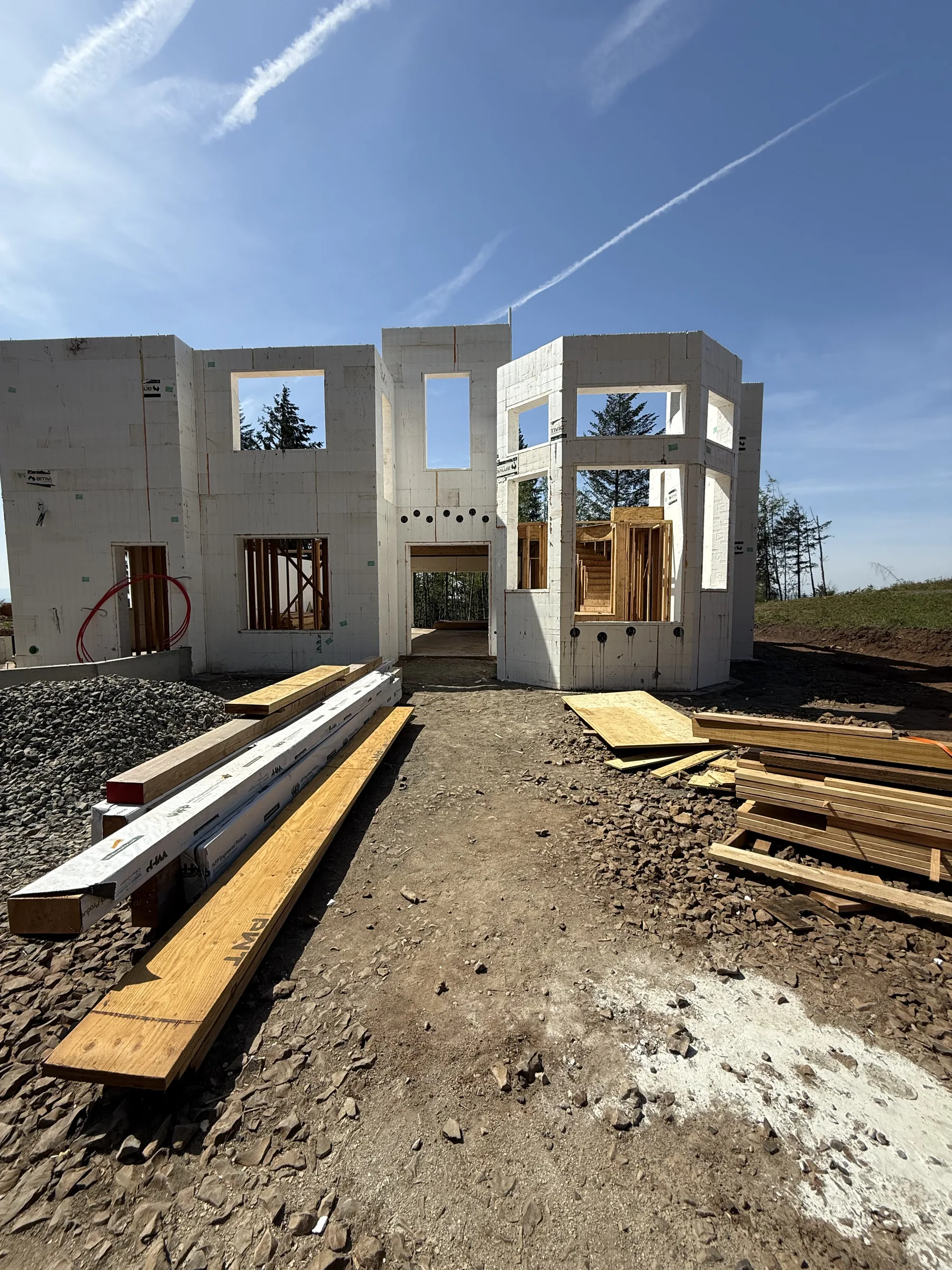 ICF shell with window bucks framed and engineered beams staged in front