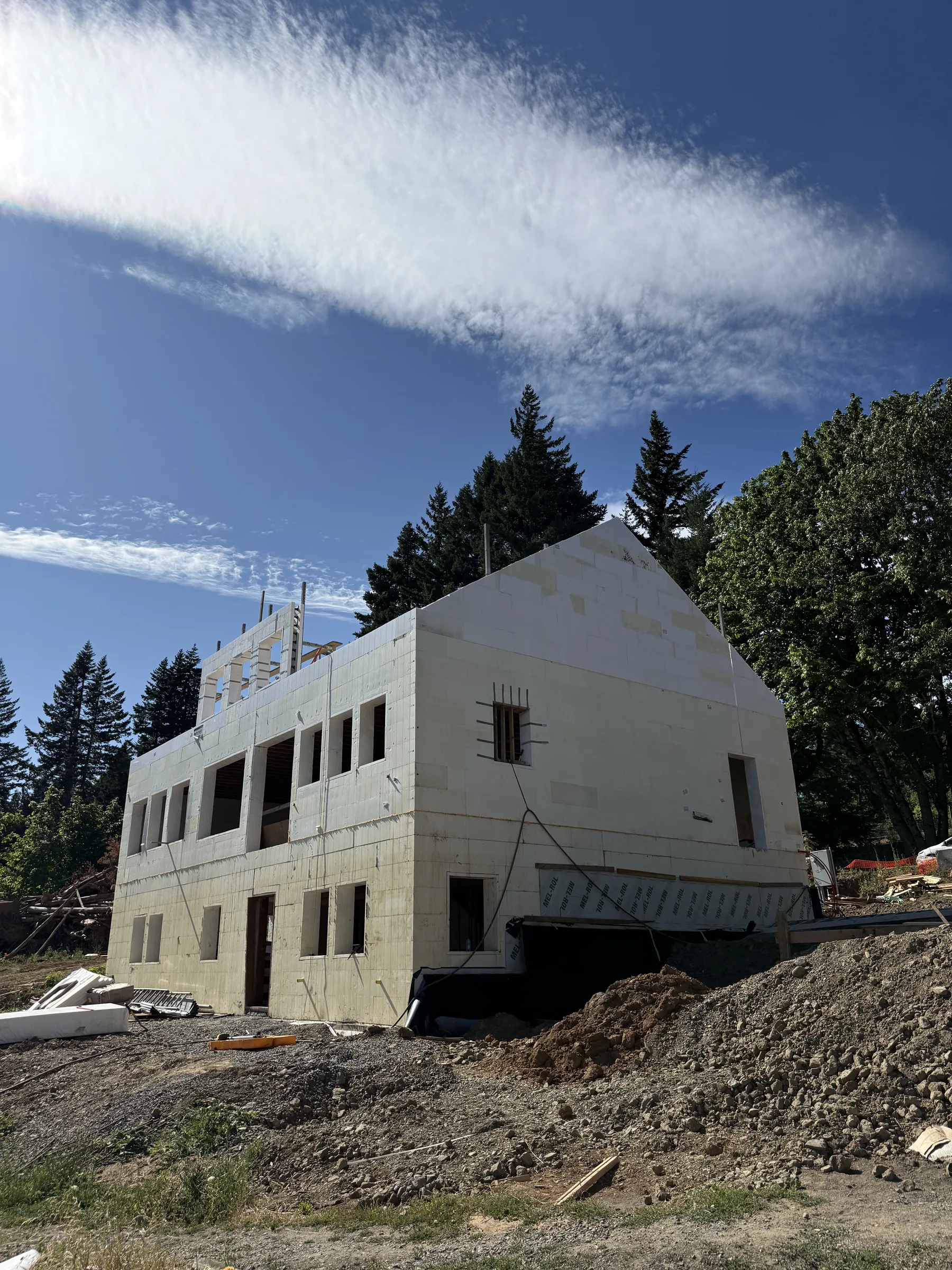 Gabled two-story ICF shell with rebar dowels exposed on top