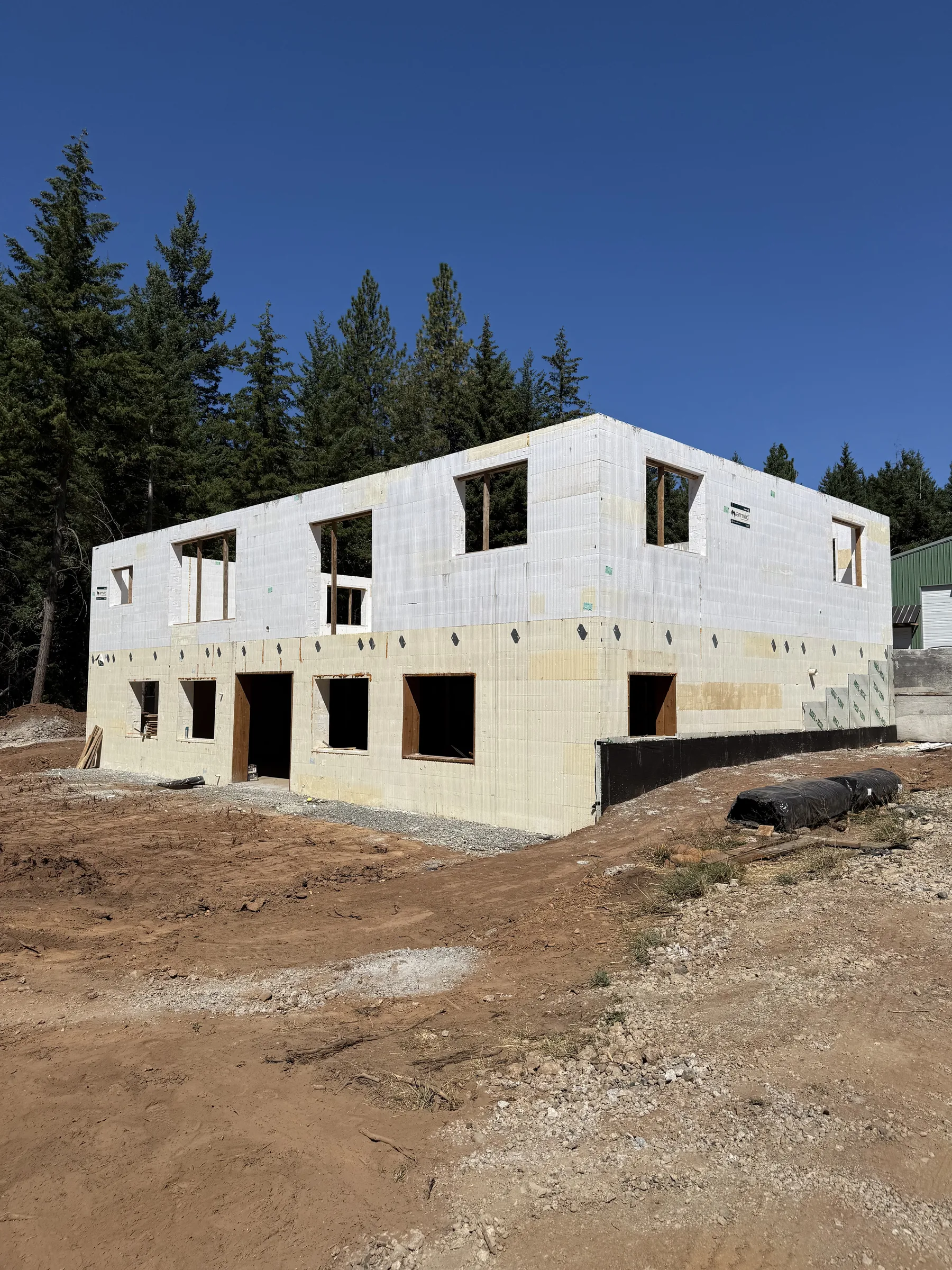 Long two-story ICF shell with garage door openings