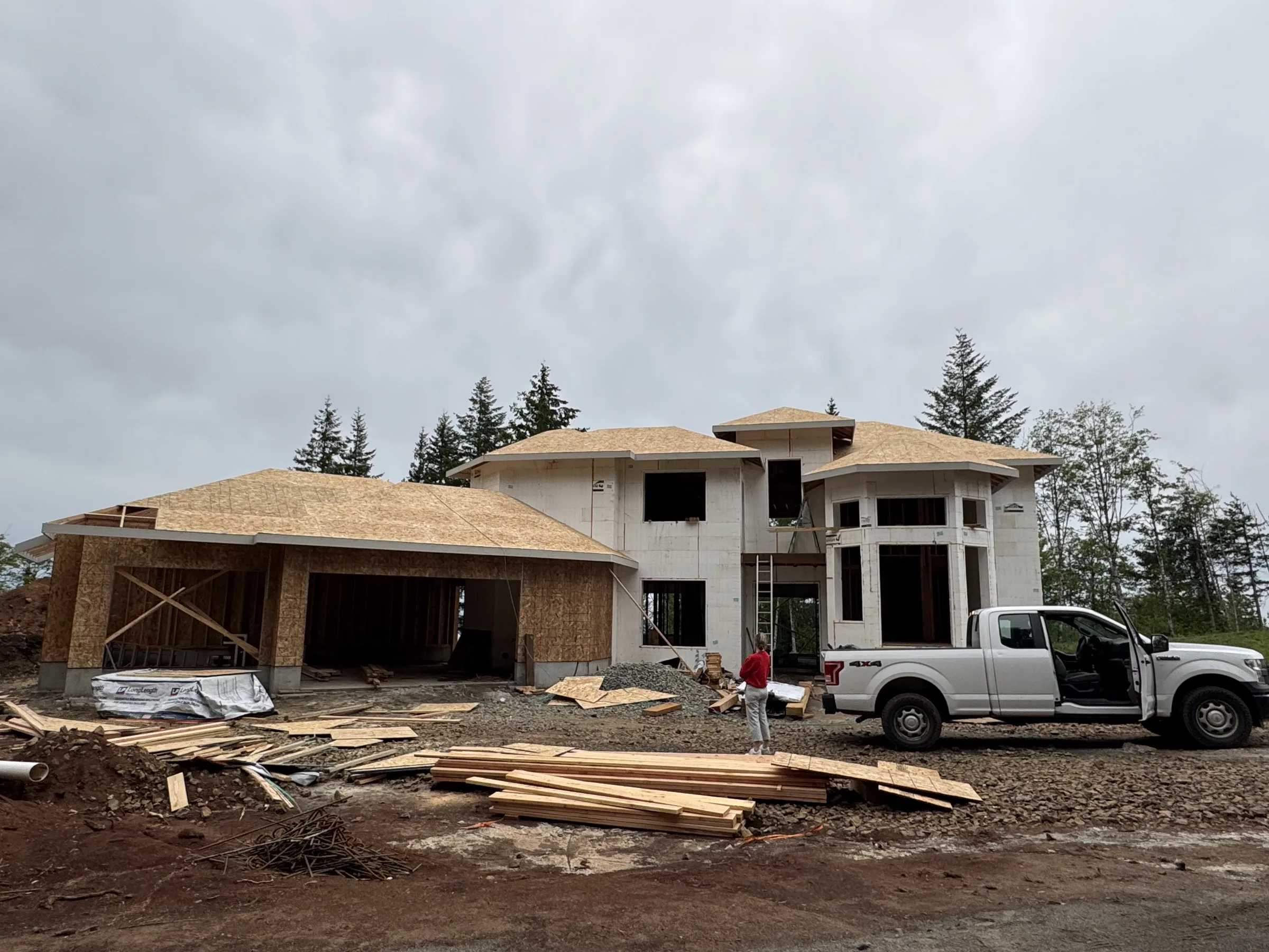 Hip-roofed ICF house with sheathed garage gable
