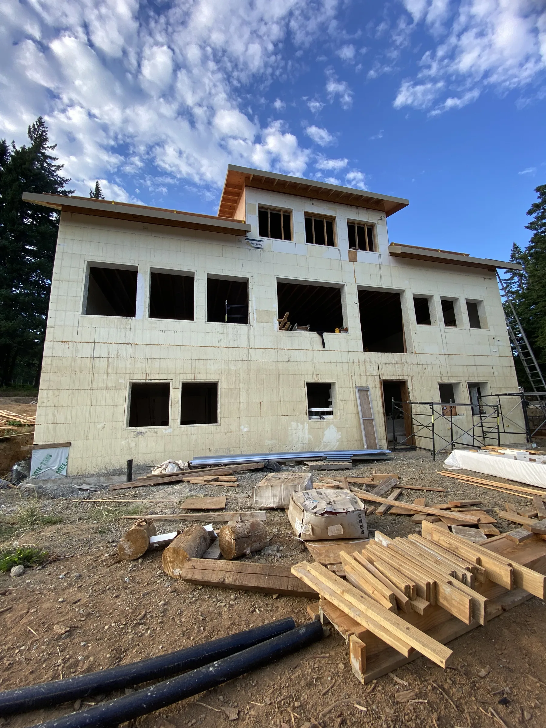 Three-story ICF shell with clerestory window band under a blue sky
